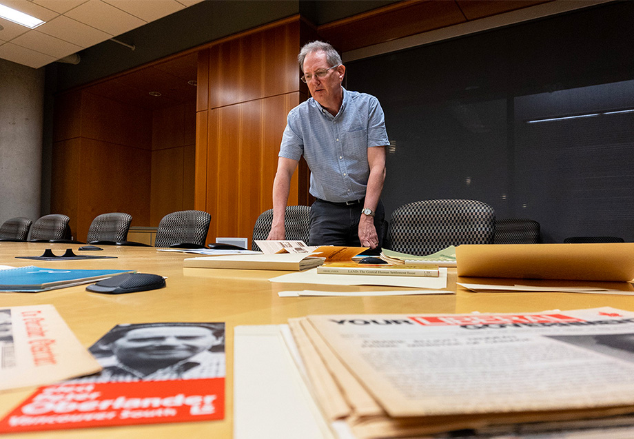 Erwin Wodarczak, Acting Head of UBC Archives, viewing selected materials from Peter Oberlander Fonds.